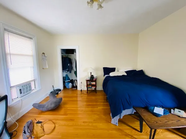 a bed room with a bed and a chair