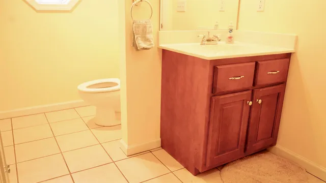 a bathroom with a sink a toilet and mirror