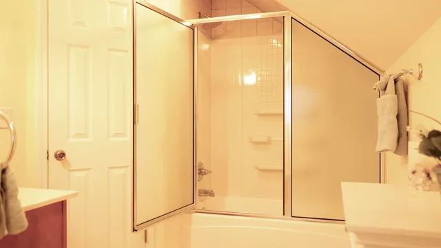 a bathroom with a shower and a glass door