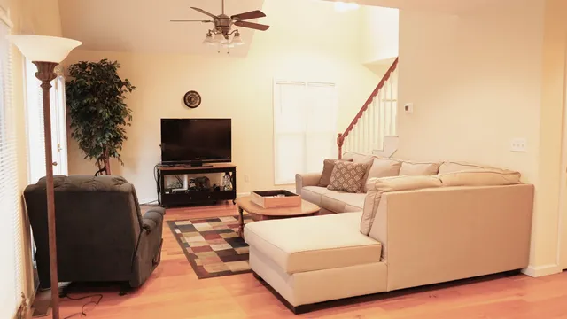 a living room with furniture and a flat screen tv