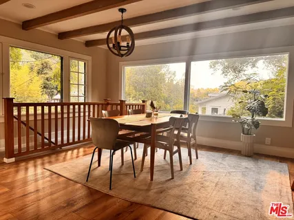 a view of a dining room with furniture window and wooden floor