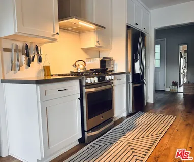 a kitchen with stainless steel appliances a stove and a refrigerator