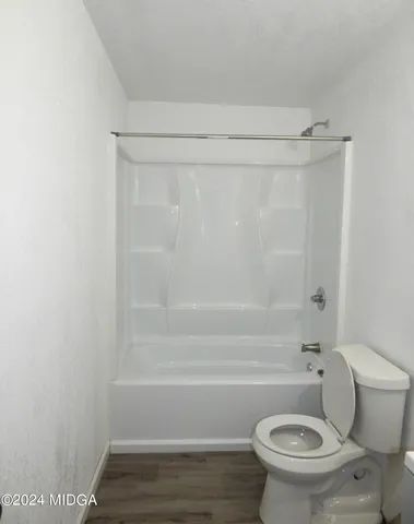 a bathroom with a toilet and shower