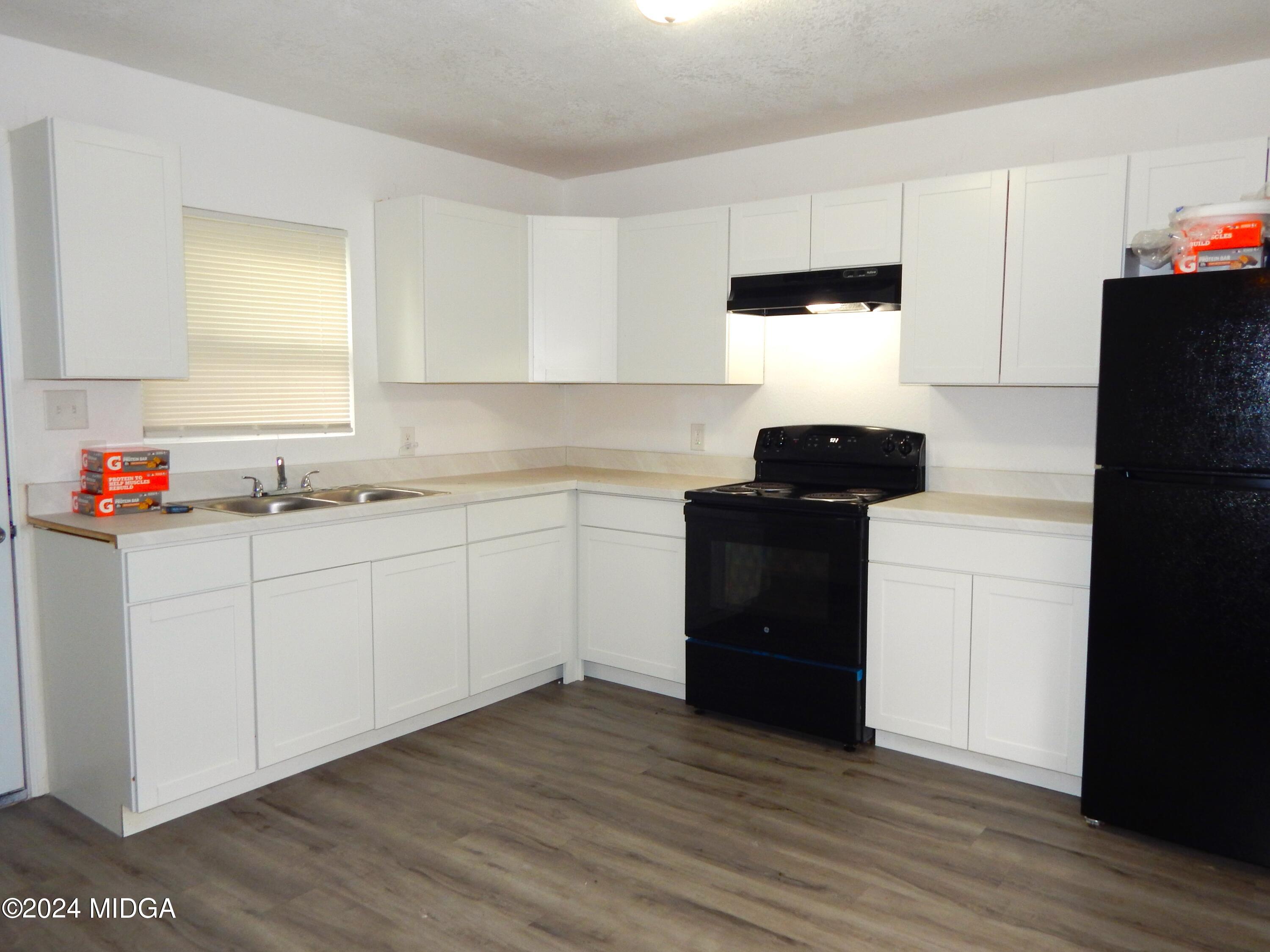 3835 Kings Park Circle Macon, GA 31217 - Photo 5 of 15 a kitchen with a refrigerator and a stove top oven