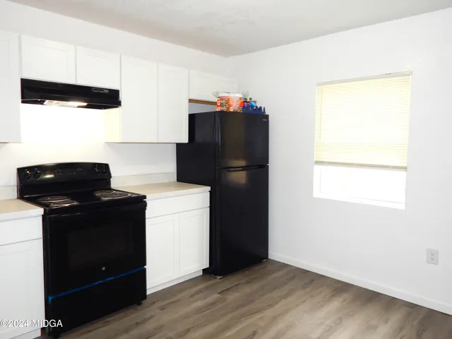 a kitchen with a refrigerator and a stove