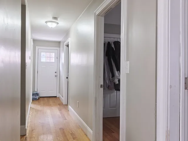 a view of a hallway with wooden floor