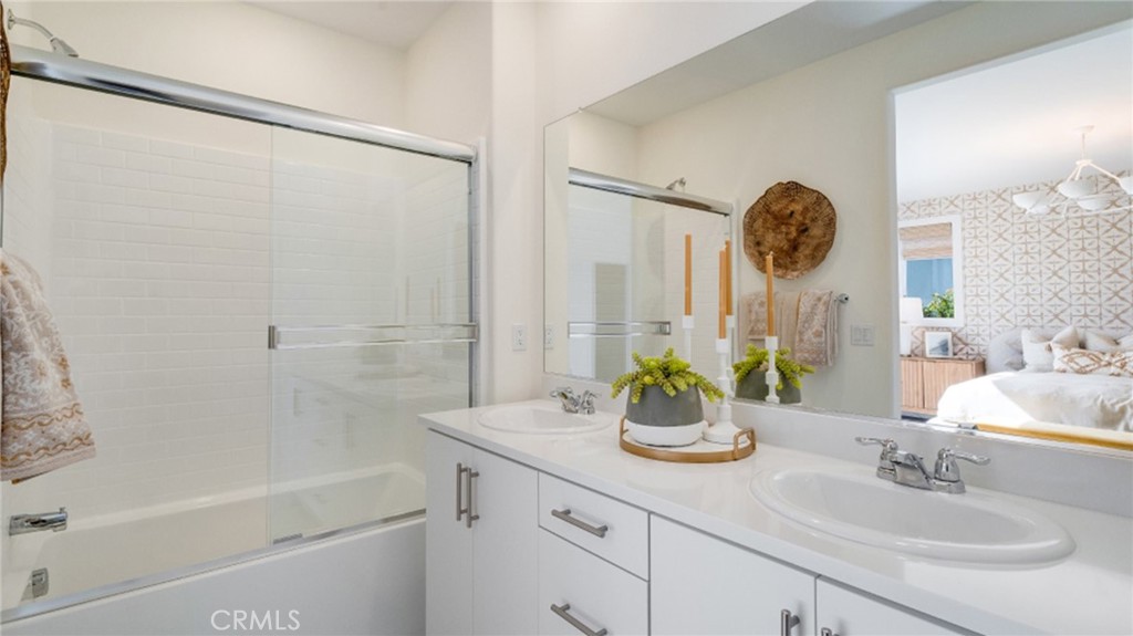 366 Sea Bright Road Perris, CA 92570 - Photo 13 of 21 a bathroom with a granite countertop sink a mirror and a bathtub