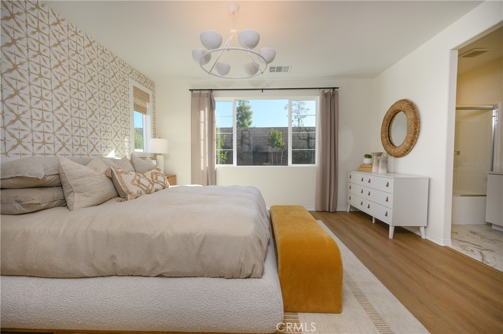 366 Sea Bright Road Perris, CA 92570 - Photo 16 of 21 a spacious bedroom with a bed a window and closet