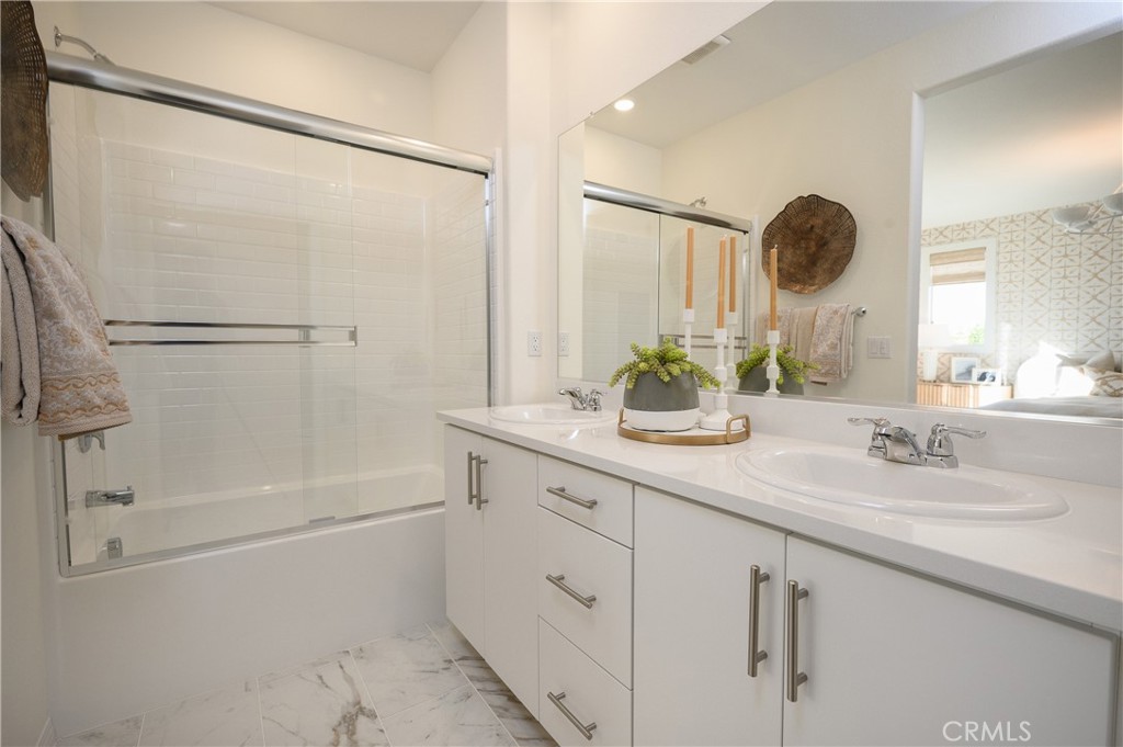 366 Sea Bright Road Perris, CA 92570 - Photo 17 of 21 a bathroom with a double vanity sink mirror and shower