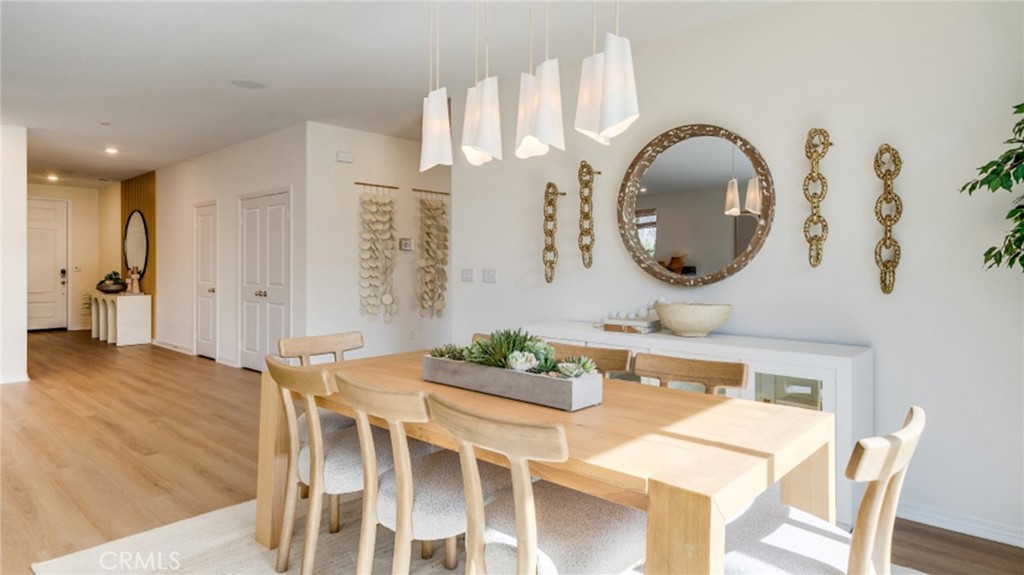 366 Sea Bright Road Perris, CA 92570 - Photo 3 of 21 a dining room with wooden floor a glass table and chairs