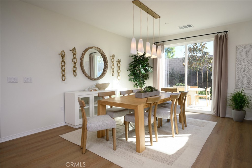 366 Sea Bright Road Perris, CA 92570 - Photo 4 of 21 a view of a dining room with furniture window and wooden floor