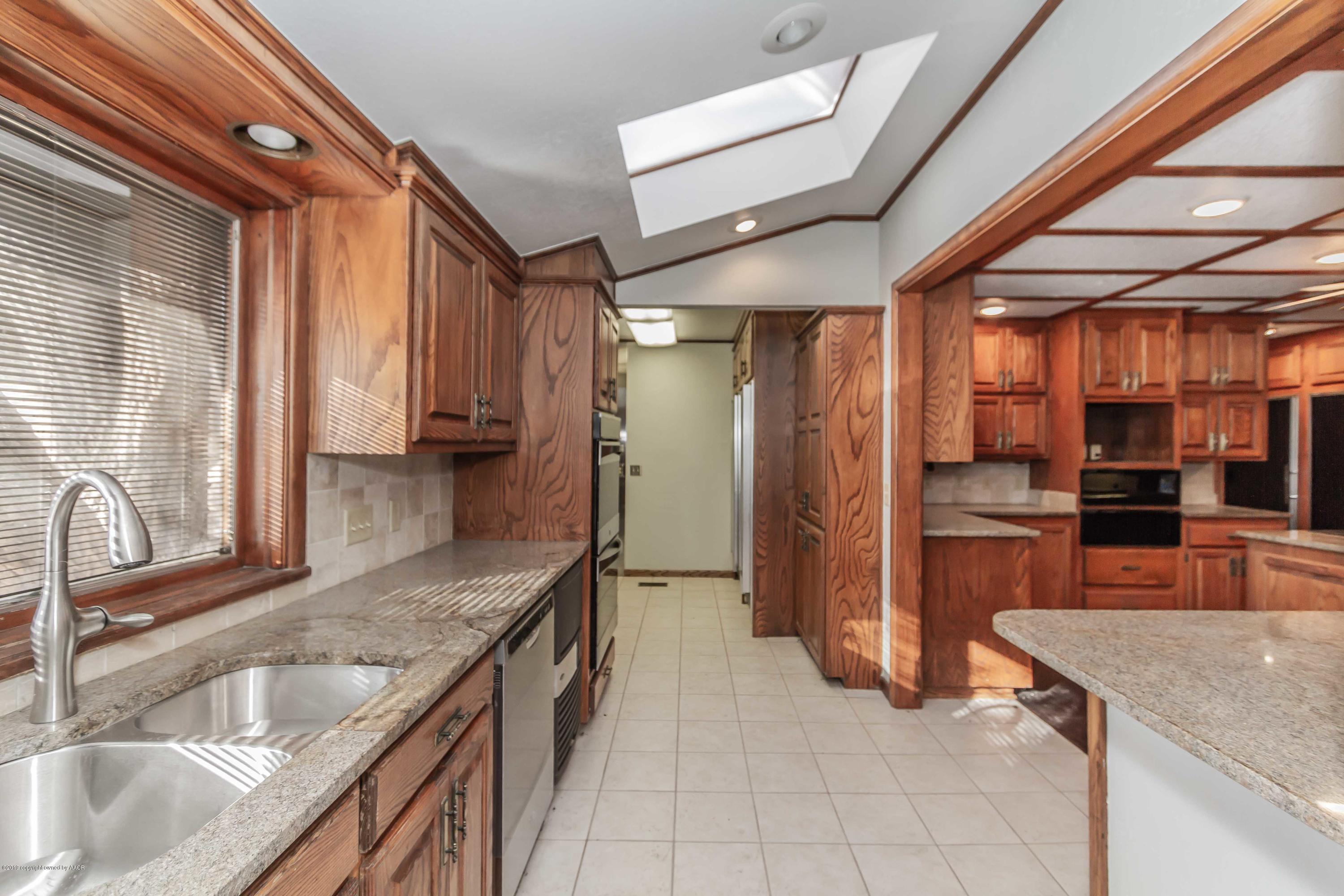6801 Green Haven Road Amarillo, TX 79110 - Photo 11 of 65 a kitchen with stainless steel appliances granite countertop a sink and a refrigerator