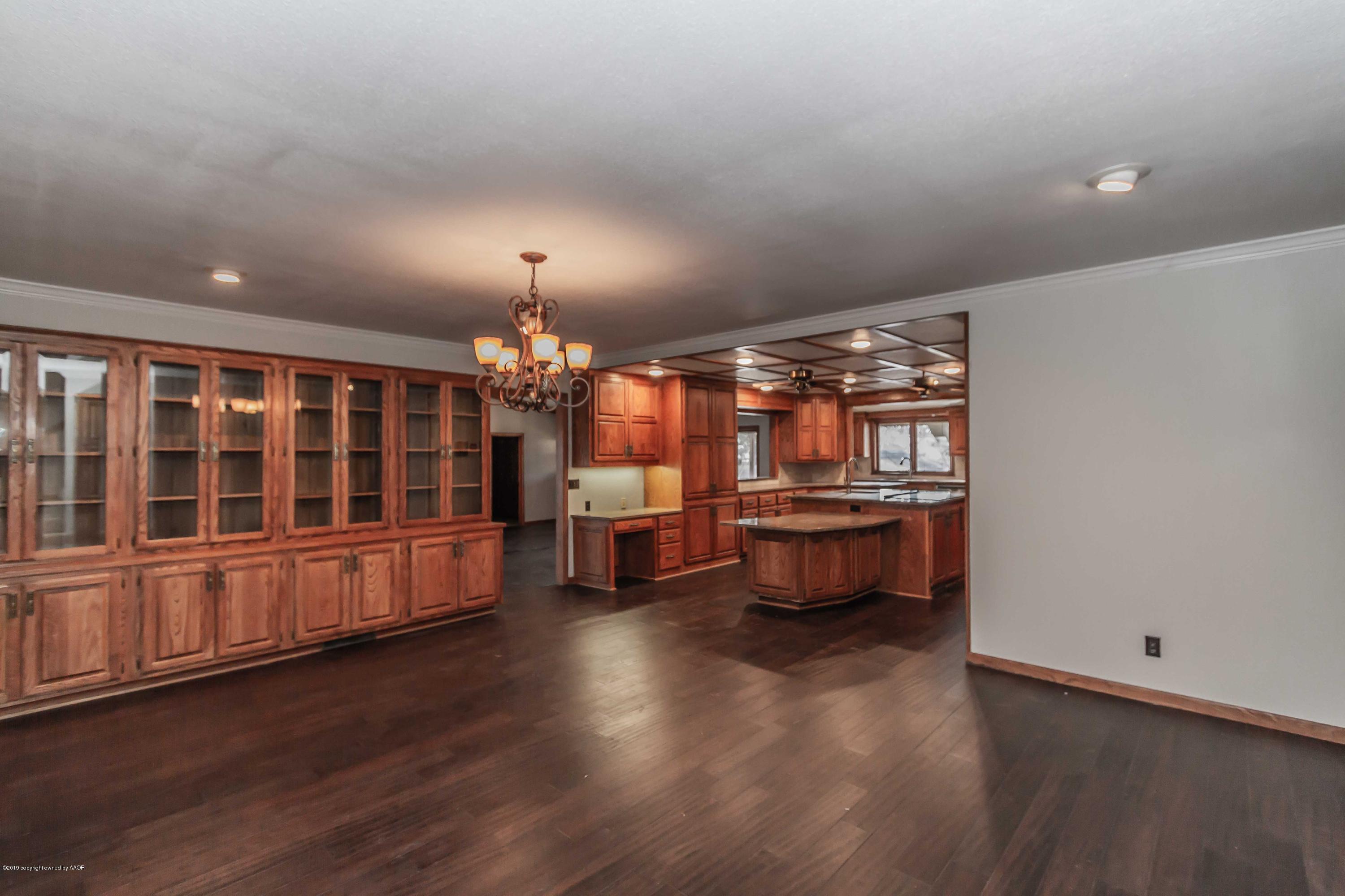 6801 Green Haven Road Amarillo, TX 79110 - Photo 13 of 65 a view of a room with wooden floor furniture and windows