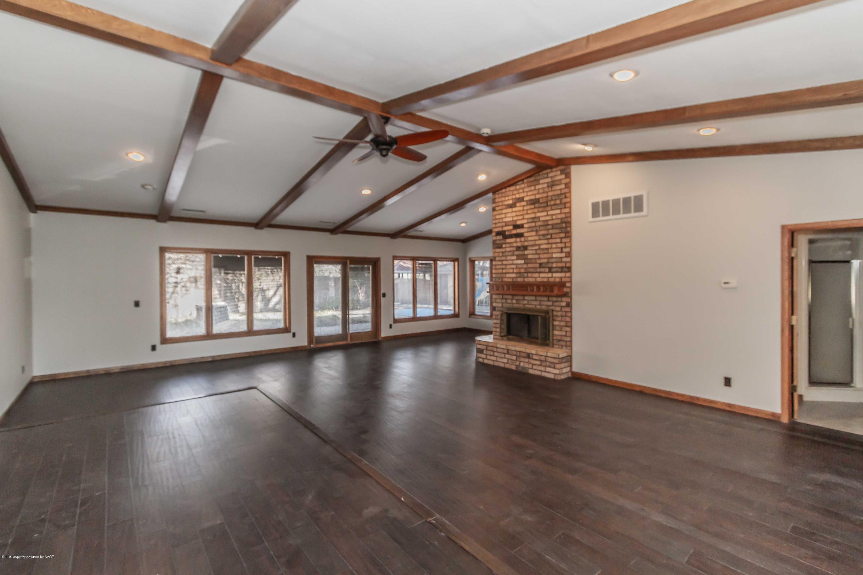 6801 Green Haven Road Amarillo, TX 79110 - Photo 16 of 65 a view of an empty room with wooden floor and a window