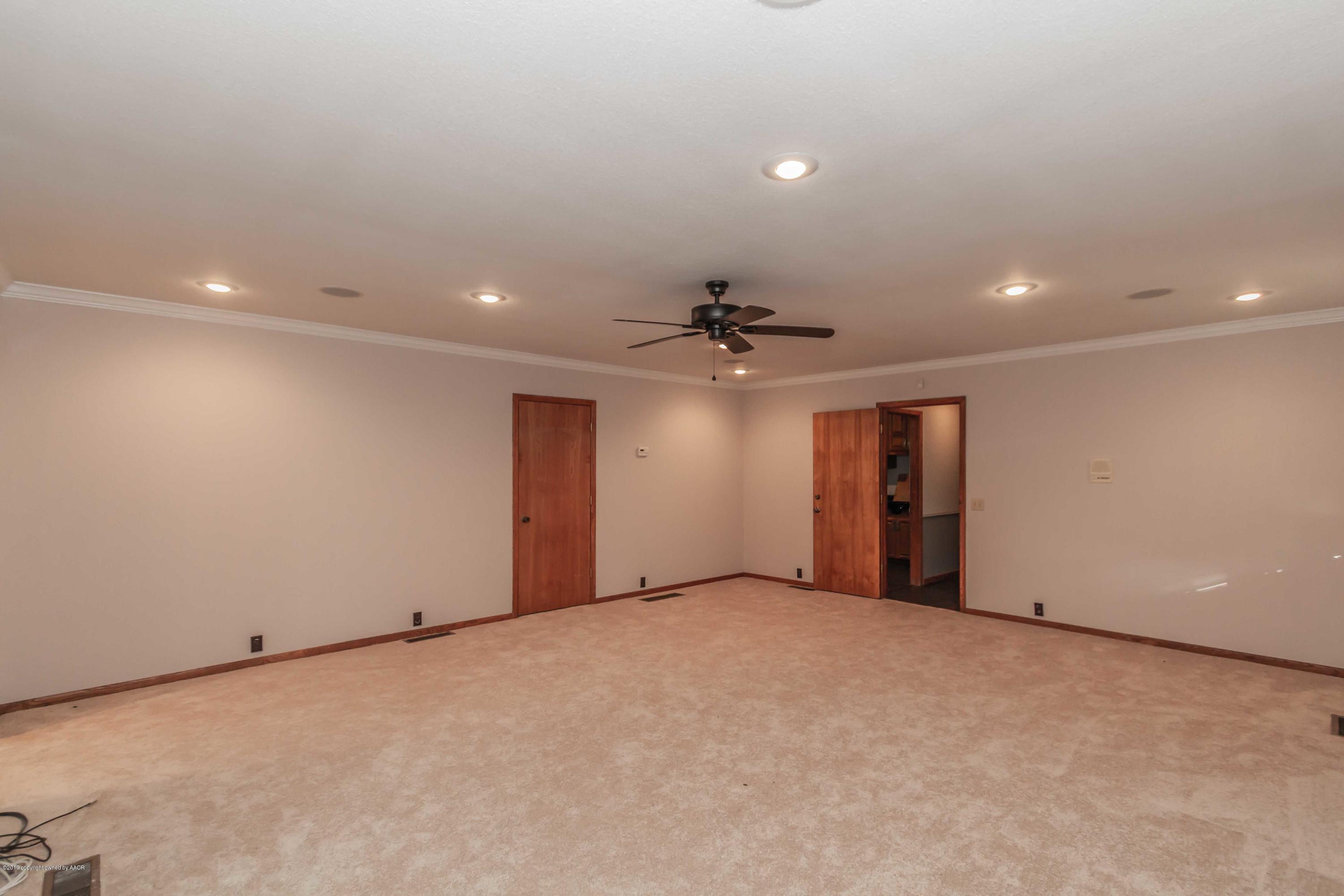 6801 Green Haven Road Amarillo, TX 79110 - Photo 21 of 65 a view of an empty room with a ceiling fan