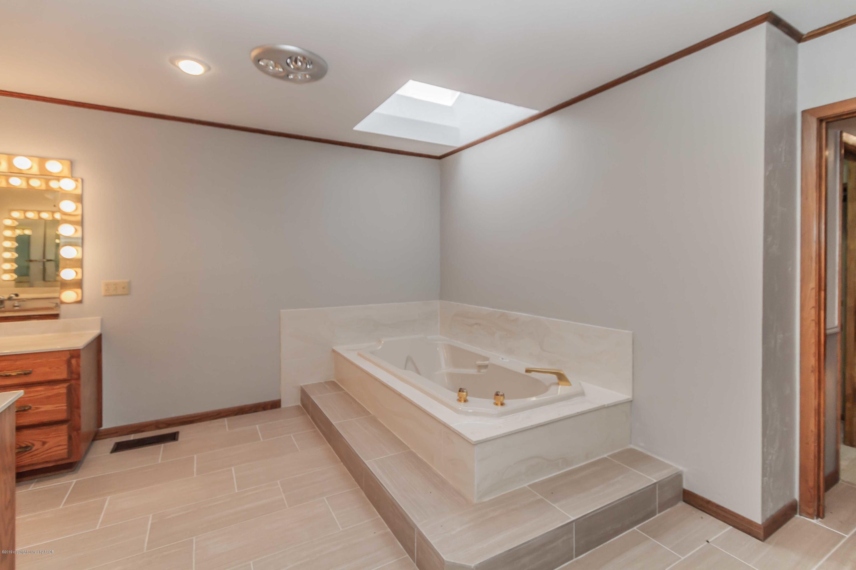 6801 Green Haven Road Amarillo, TX 79110 - Photo 23 of 65 a bathroom with a tub and a sink