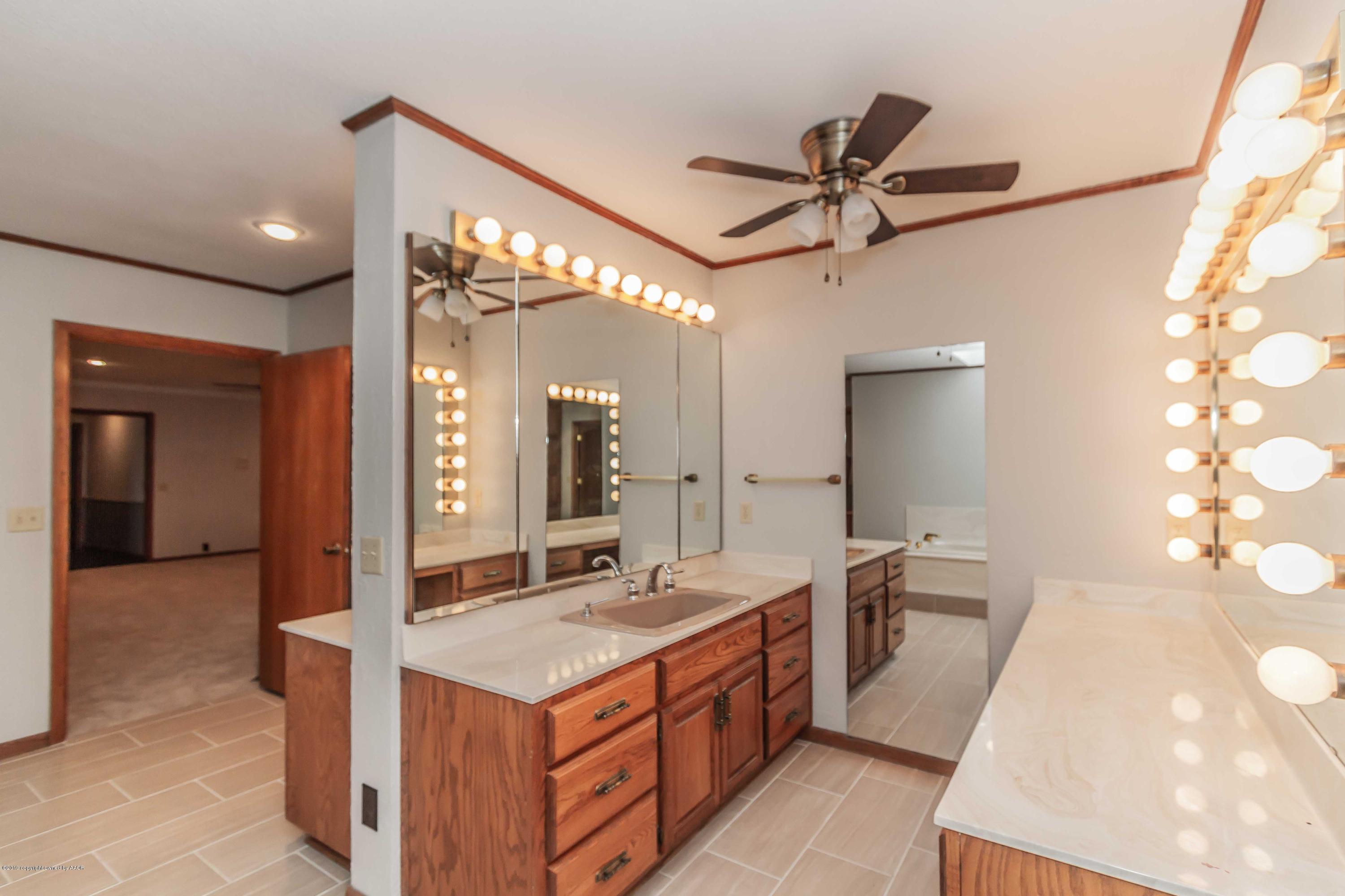 6801 Green Haven Road Amarillo, TX 79110 - Photo 24 of 65 a spacious bathroom with a double vanity sink a mirror and a shower