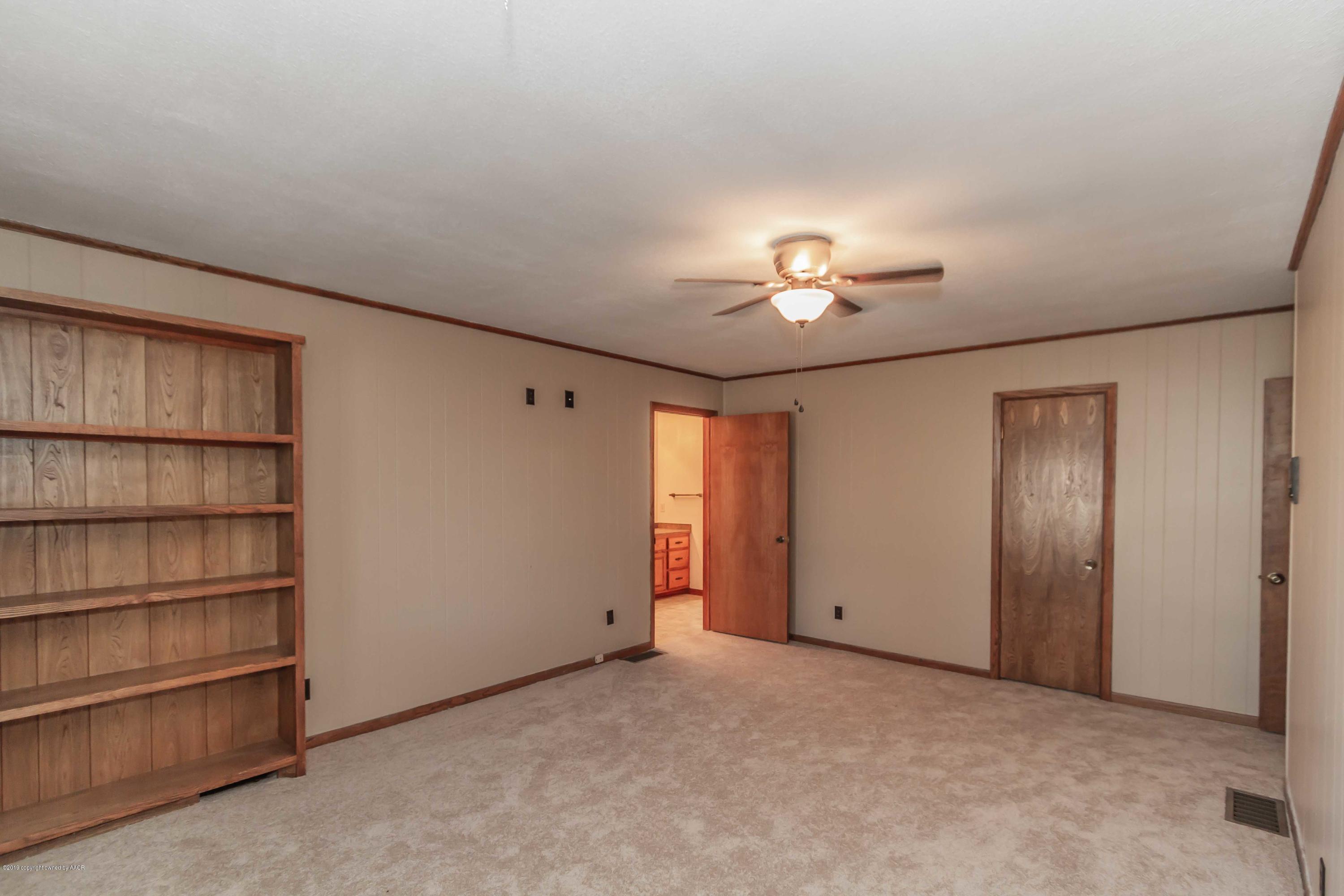 6801 Green Haven Road Amarillo, TX 79110 - Photo 30 of 65 a view of a livingroom with a chandelier fan and closet
