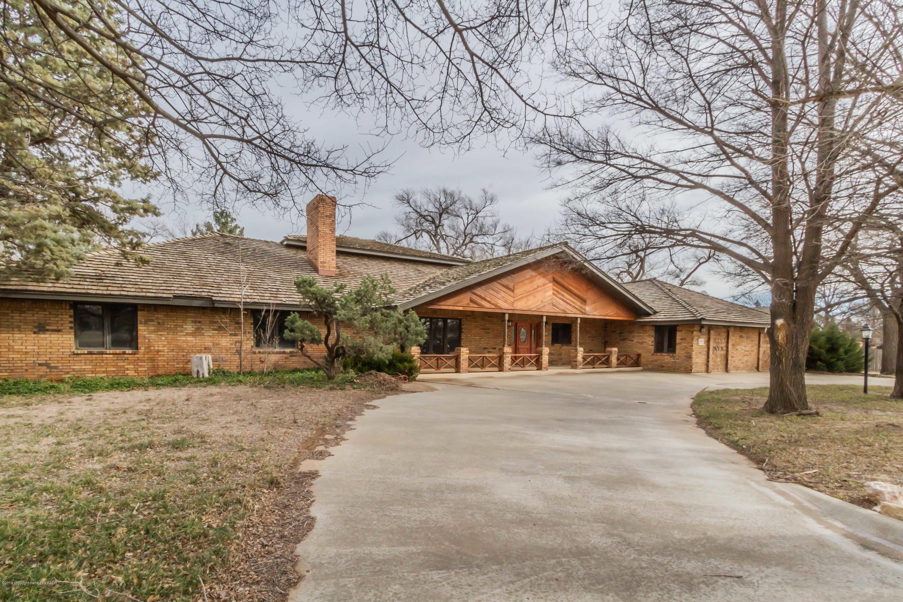 6801 Green Haven Road Amarillo, TX 79110 - Photo 4 of 65 a front view of a house with a yard