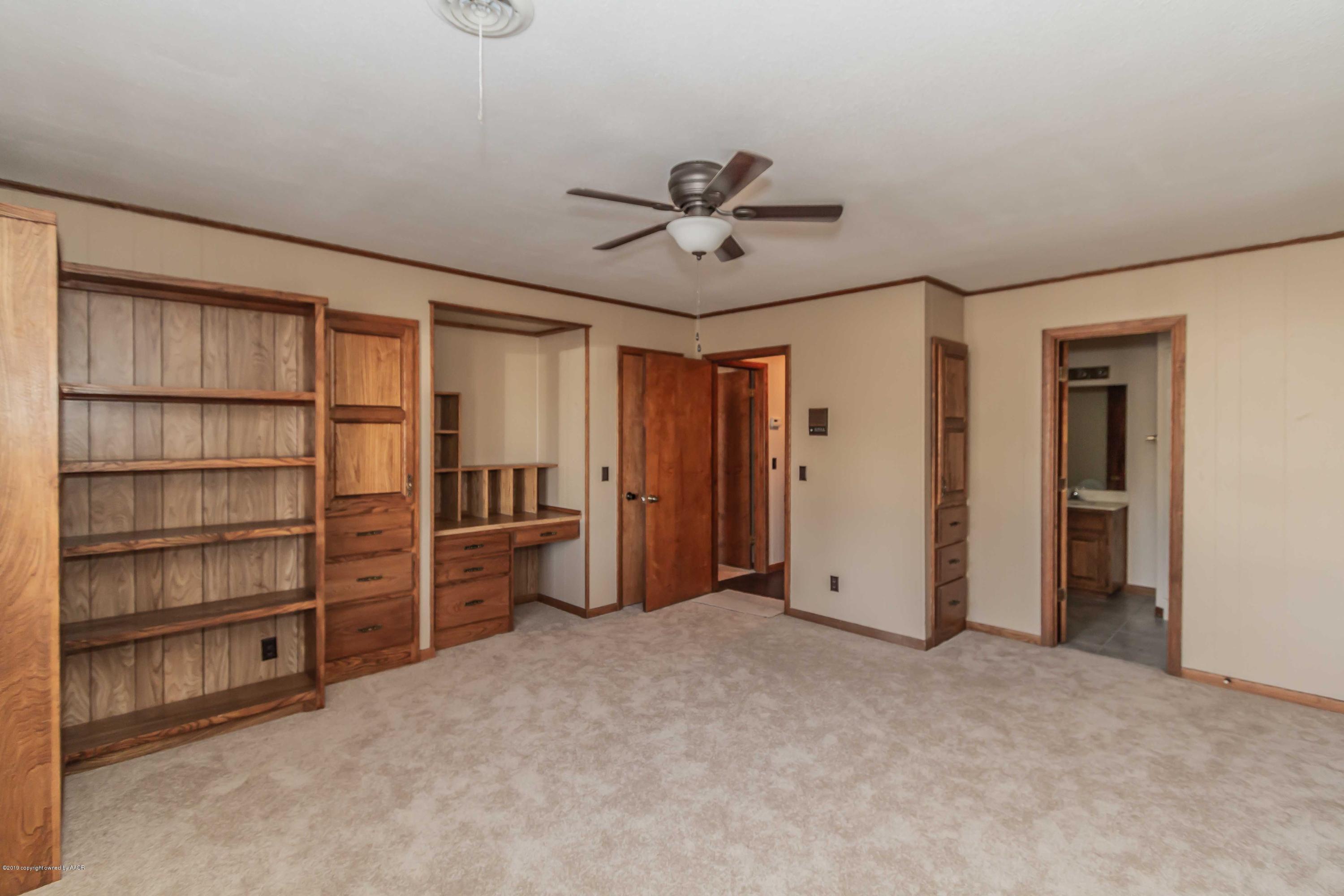 6801 Green Haven Road Amarillo, TX 79110 - Photo 34 of 65 a view of empty room with cabinet and ceiling fan