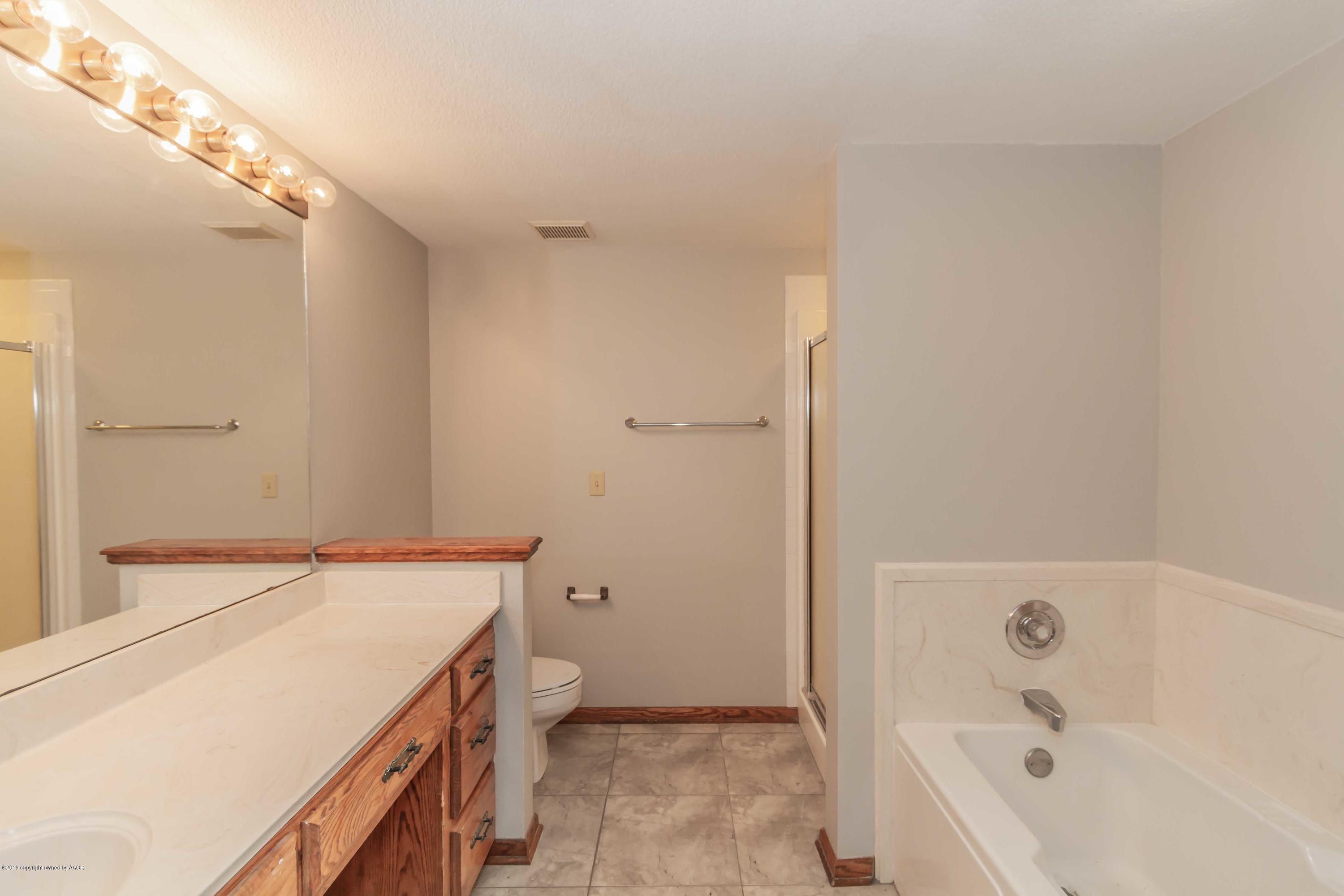 6801 Green Haven Road Amarillo, TX 79110 - Photo 42 of 65 a bathroom with a bathtub and a shower