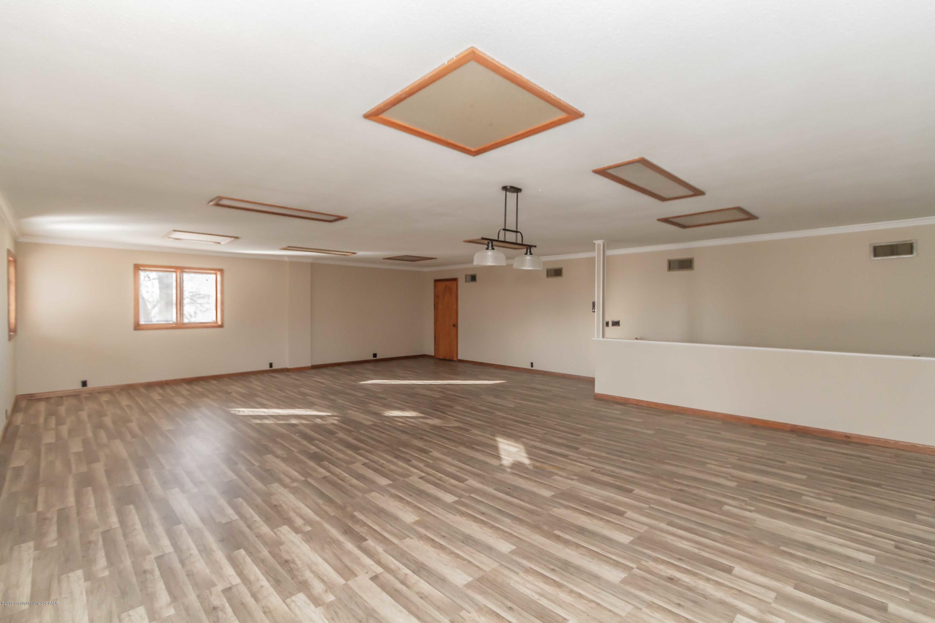 6801 Green Haven Road Amarillo, TX 79110 - Photo 49 of 65 a view of empty room with wooden floor