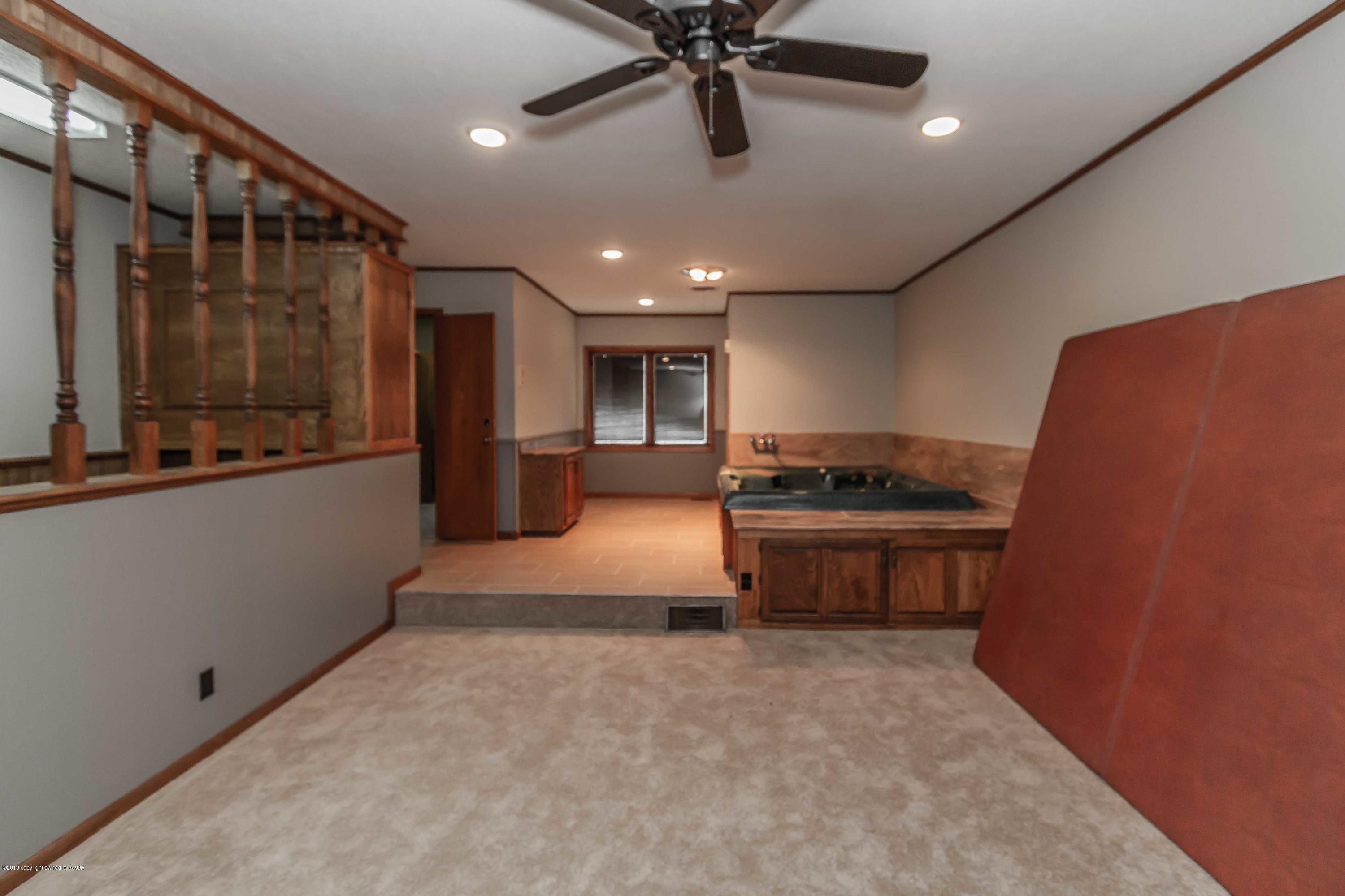 6801 Green Haven Road Amarillo, TX 79110 - Photo 52 of 65 a large kitchen with stainless steel appliances a large counter top a stove and a refrigerator