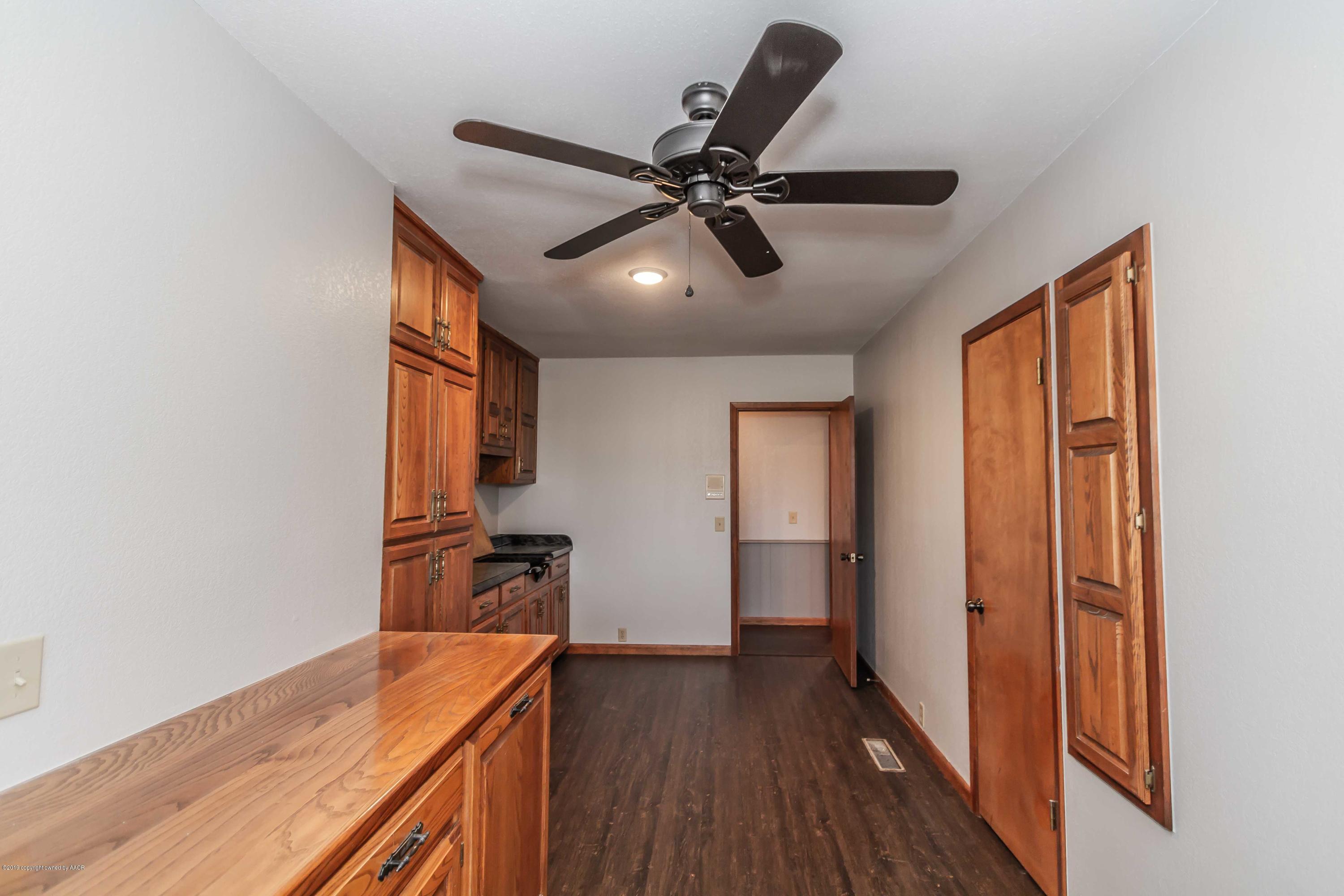 6801 Green Haven Road Amarillo, TX 79110 - Photo 58 of 65 a view of a room with wooden floor and a ceiling fan