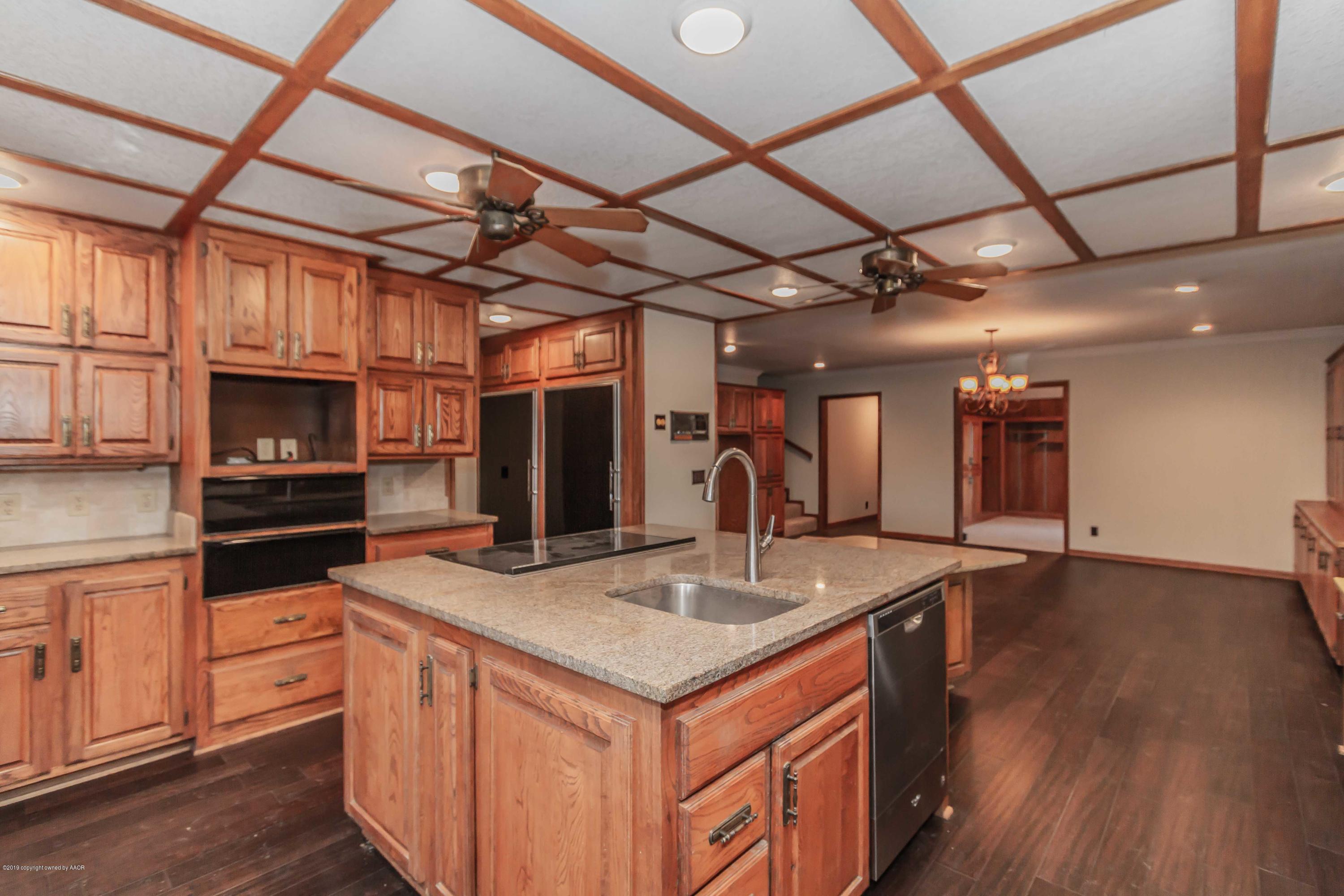 6801 Green Haven Road Amarillo, TX 79110 - Photo 10 of 65 a kitchen with stainless steel appliances granite countertop a sink and a refrigerator