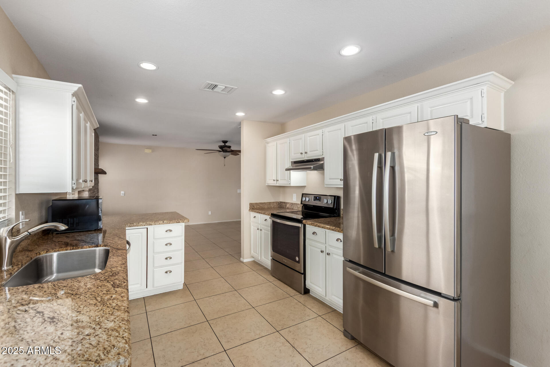 7412 East Ed Rice Avenue Mesa, AZ 85208 - Photo 17 of 36 a kitchen with stainless steel appliances granite countertop a refrigerator a stove and a sink