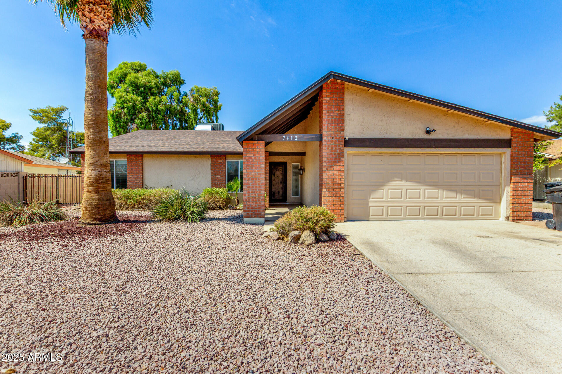 7412 East Ed Rice Avenue Mesa, AZ 85208 - Photo 2 of 36 a front view of a house with a yard and garage