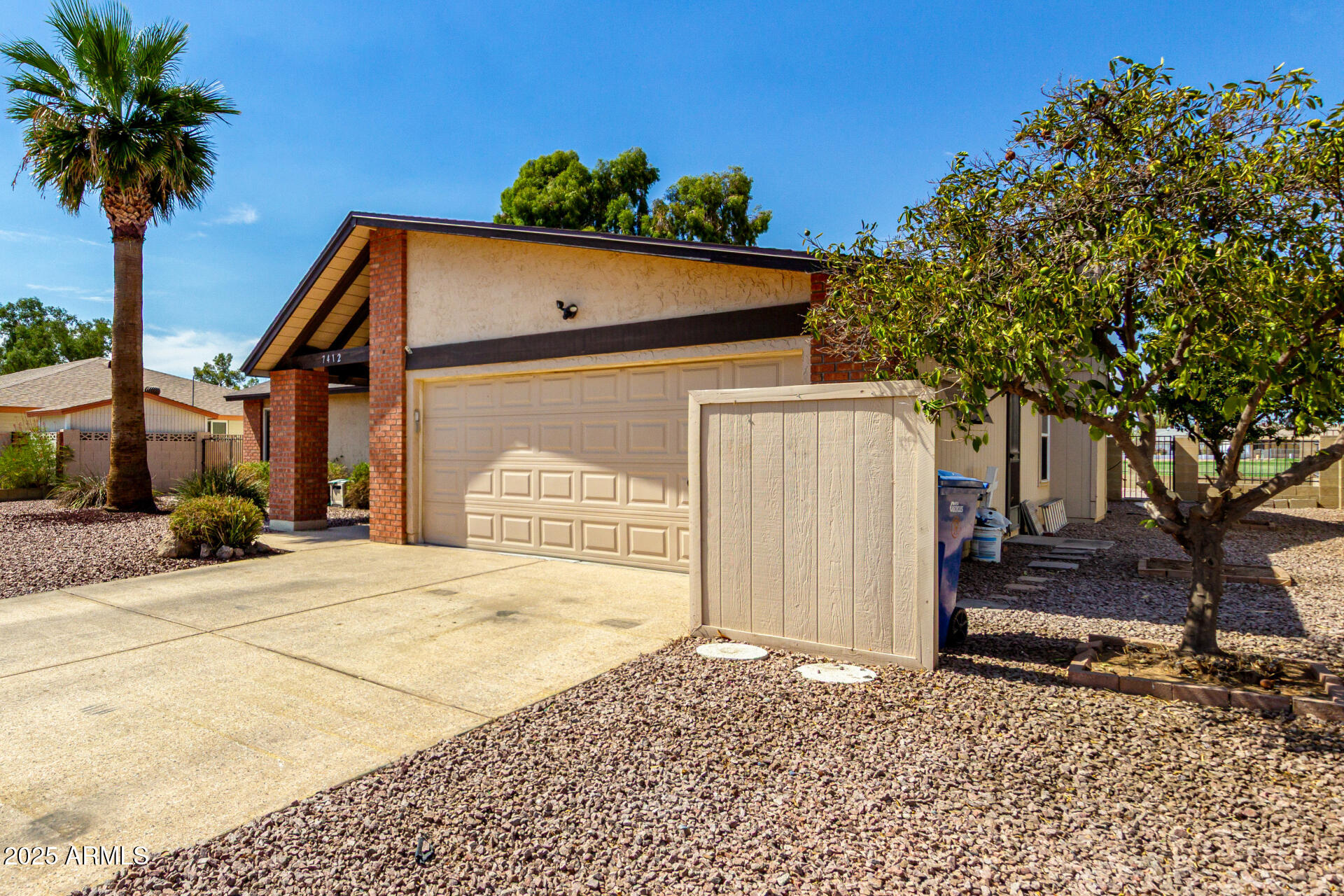 7412 East Ed Rice Avenue Mesa, AZ 85208 - Photo 5 of 36 a front view of a house with a yard and garage