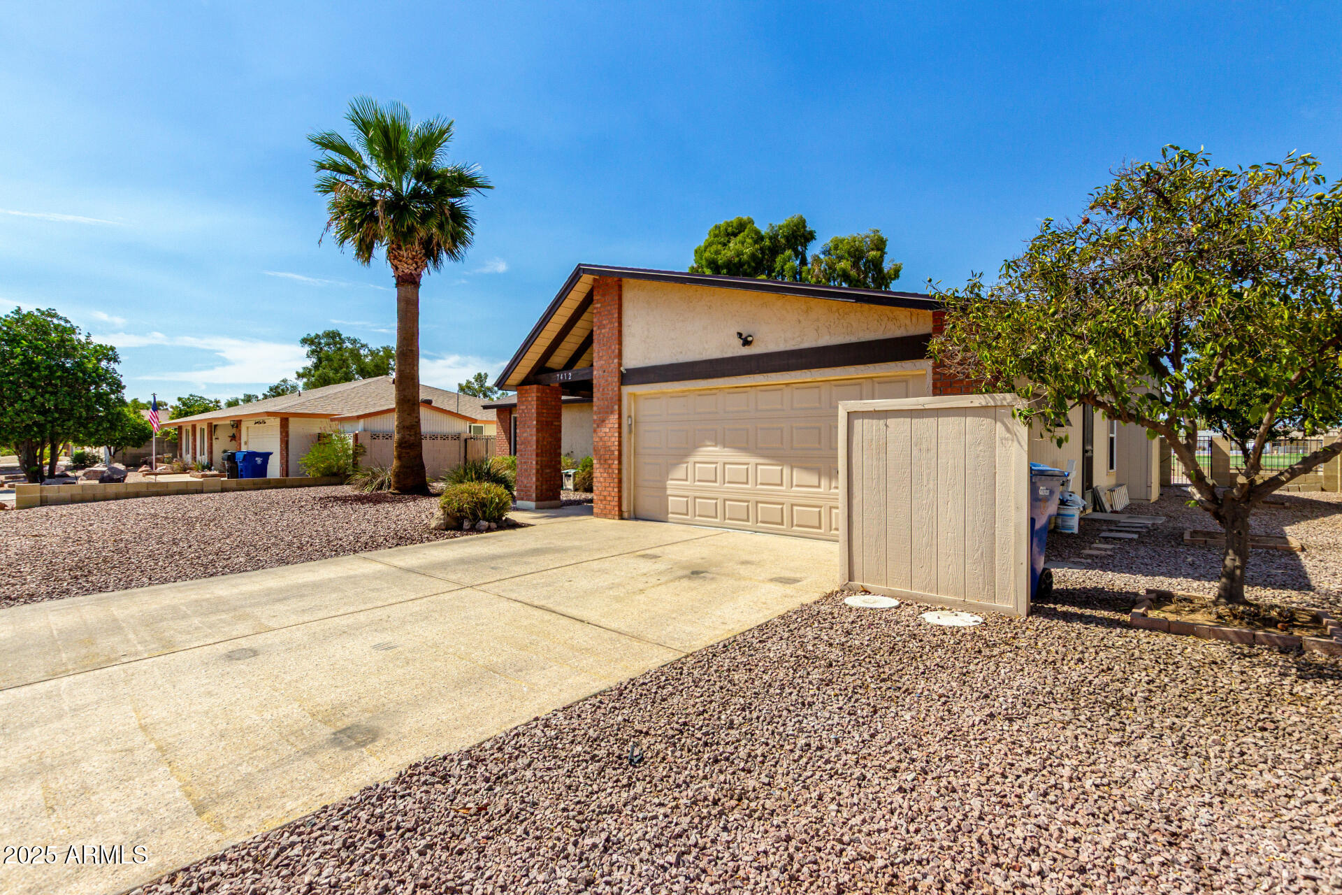 7412 East Ed Rice Avenue Mesa, AZ 85208 - Photo 6 of 36 a front view of a house with a yard and garage