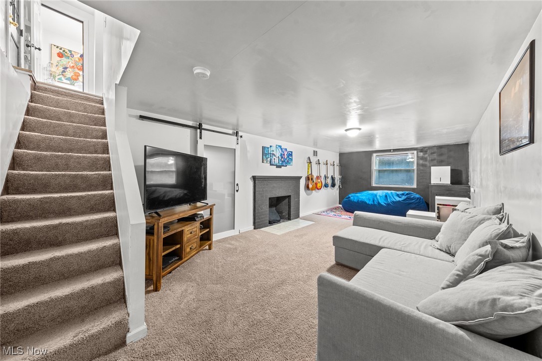 2323 Saybrook Road Cleveland, OH 44118 - Photo 33 of 42 Carpeted living room with baseboards, a fireplace, and stairway