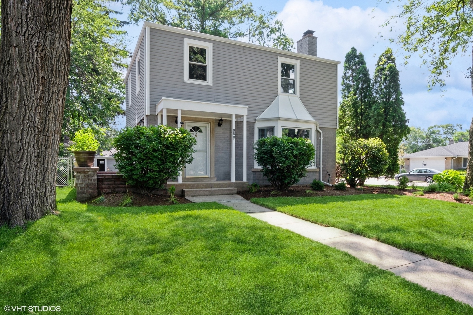 8501 Harding Avenue Skokie, IL 60076 - Photo 1 of 37 a front view of house with yard and green space