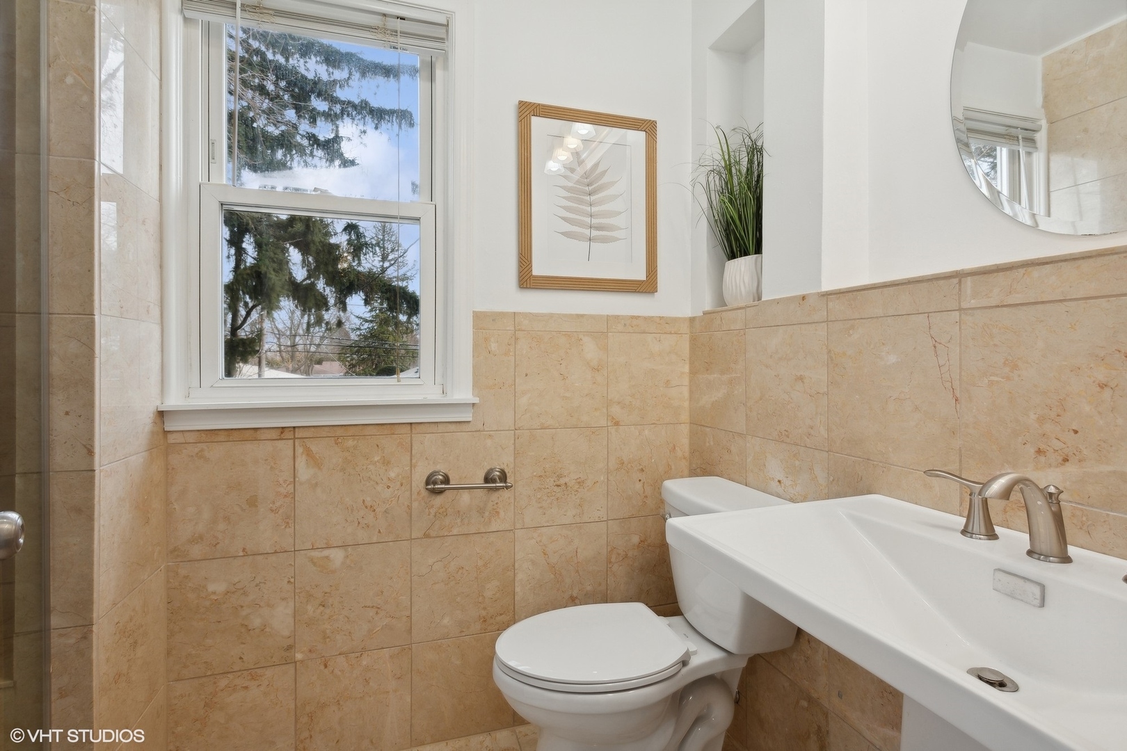 8501 Harding Avenue Skokie, IL 60076 - Photo 24 of 37 a bathroom with a toilet a sink and mirror