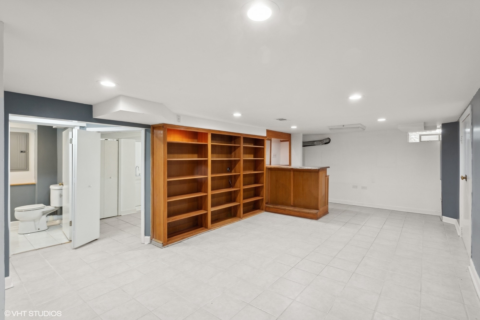 8501 Harding Avenue Skokie, IL 60076 - Photo 28 of 37 a view of an empty room with a cabinet and mirrors