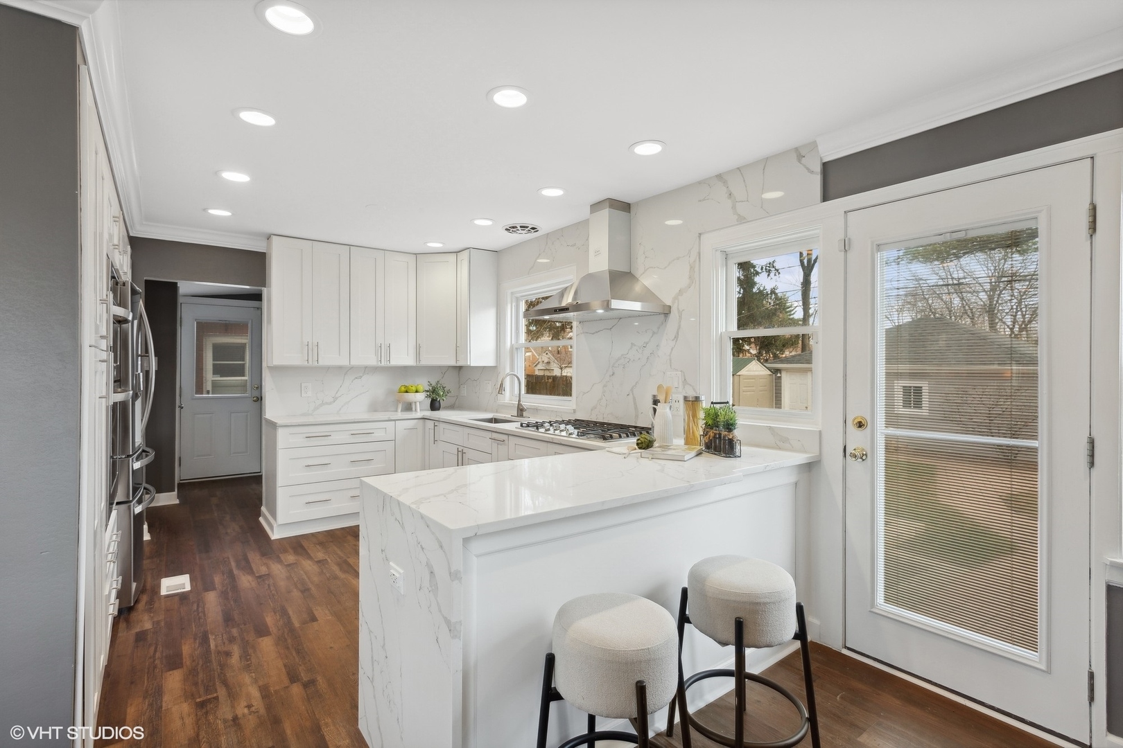 8501 Harding Avenue Skokie, IL 60076 - Photo 10 of 37 a large kitchen with kitchen island a large counter top space a sink stainless steel appliances and cabinets