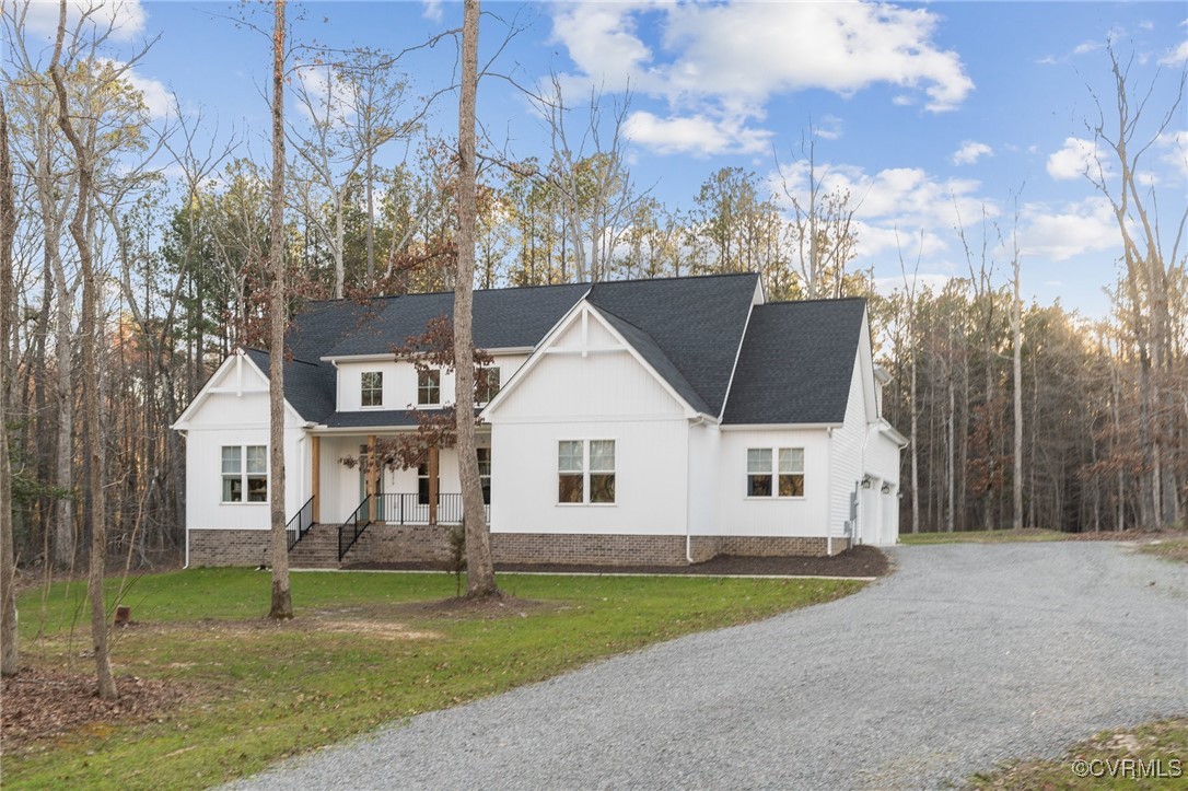 Modern farmhouse featuring a porch, a shingled roo