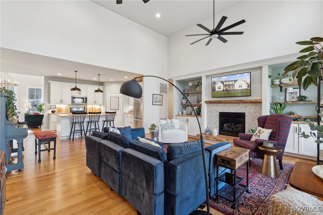 Living room featuring a fireplace, visible vents,