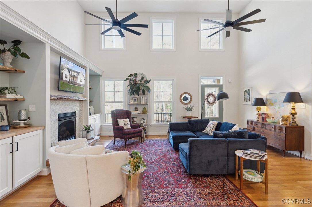Living room featuring a glass covered fireplace, a