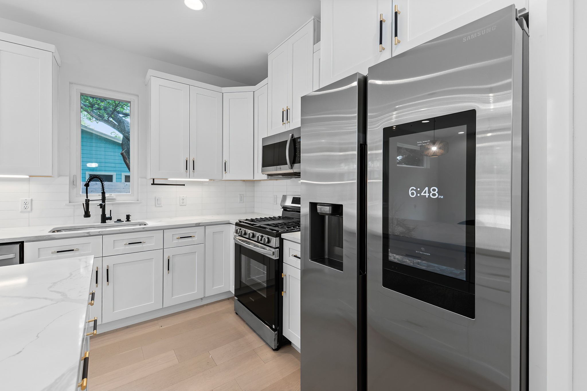 5305 Ledesma Road, Unit 4 Austin, TX 78721 - Photo 8 of 40 Culinary delights await in this bright kitchen with contemporary finishes and abundant storage.