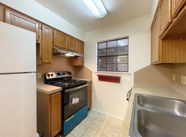 a kitchen with stainless steel appliances granite countertop a stove and a refrigerator