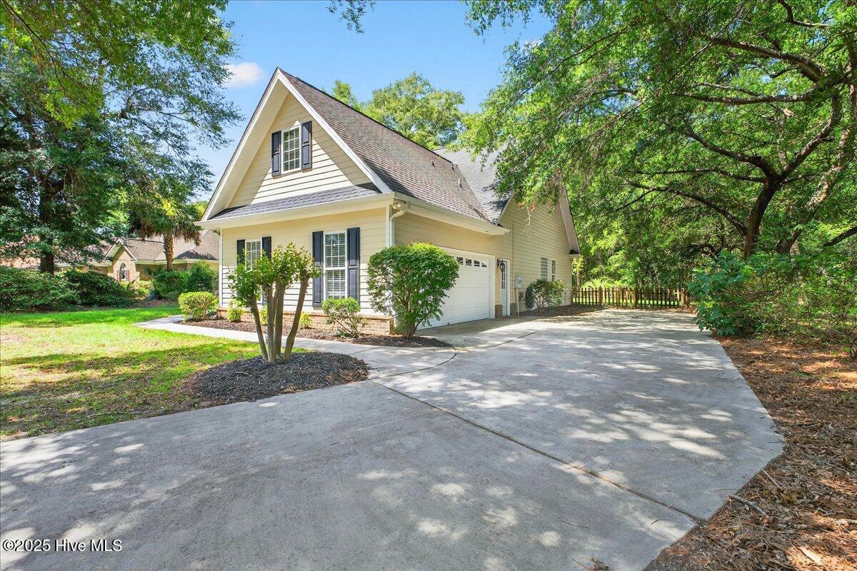 8985 Woodbine Road Southwest Sunset Beach, NC 28468 - Photo 8 of 65 Front exterior showing the garage and side entrance