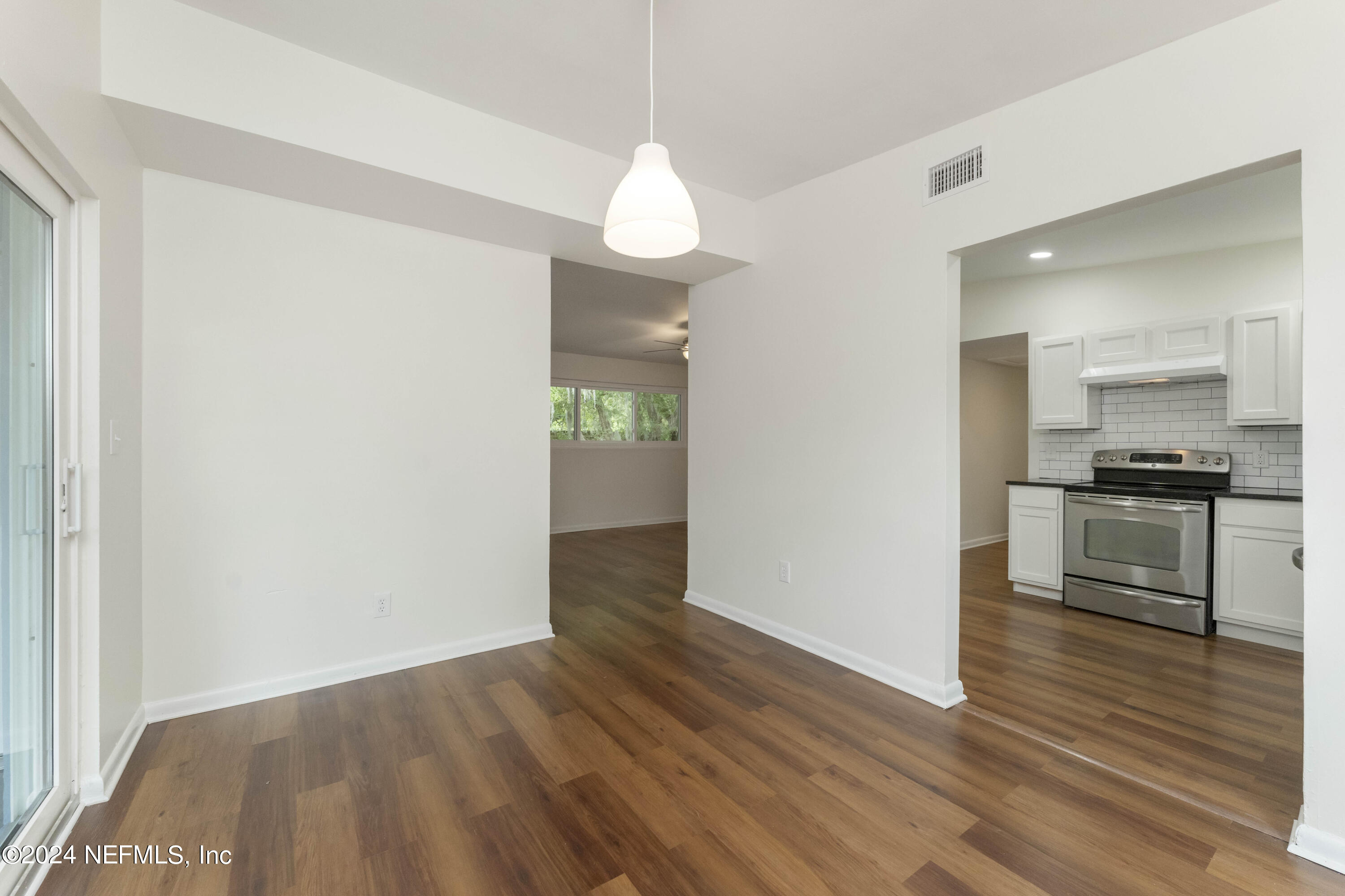 6937 Rollo Road Jacksonville, FL 32205 - Photo 11 of 26 a view of kitchen with granite countertop stainless steel appliances and wooden floor