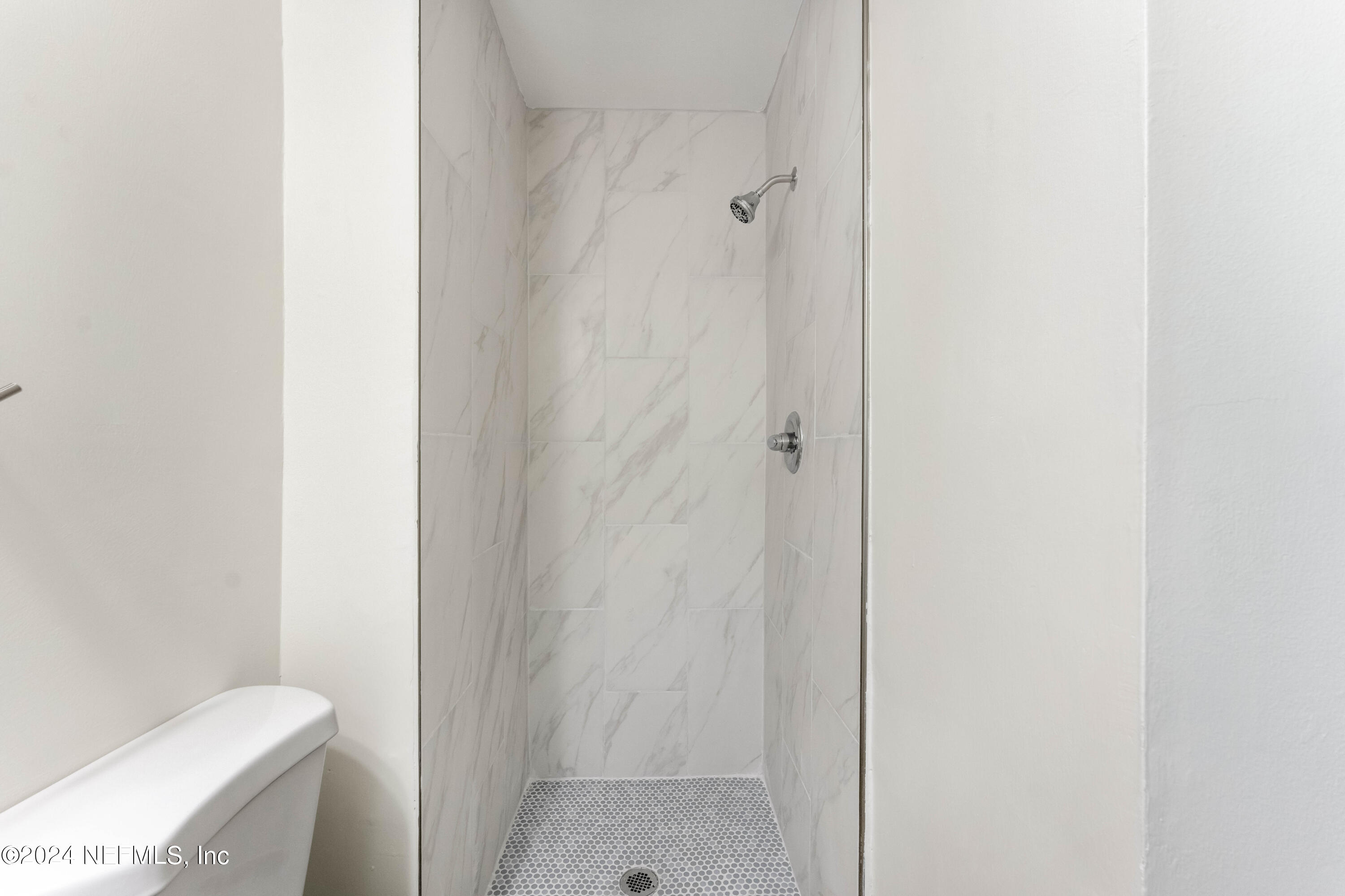 6937 Rollo Road Jacksonville, FL 32205 - Photo 18 of 26 a bathroom with a shower