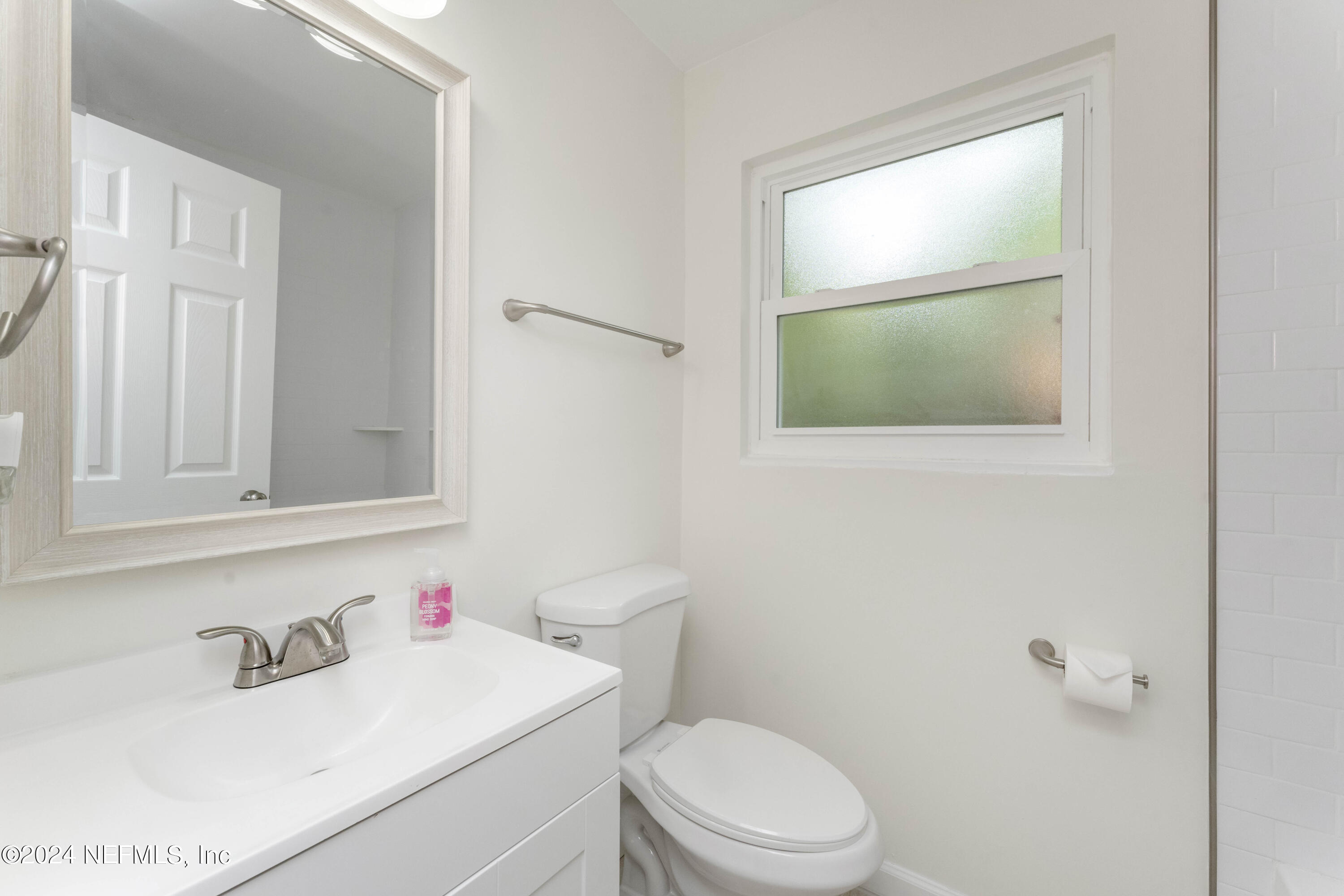 6937 Rollo Road Jacksonville, FL 32205 - Photo 20 of 26 a white toilet sitting next to a bathroom sink