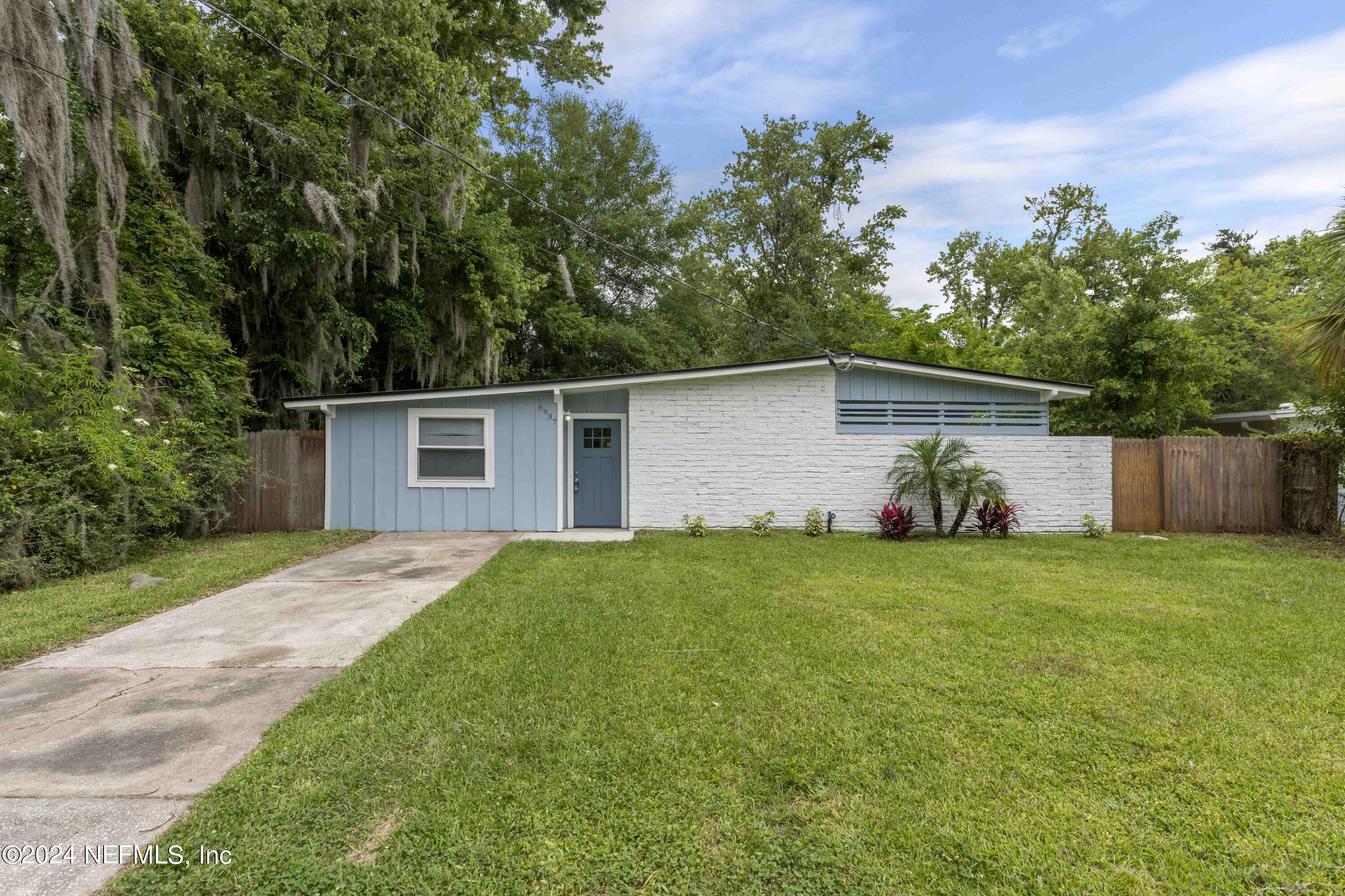 6937 Rollo Road Jacksonville, FL 32205 - Photo 2 of 26 front view of a house with a yard