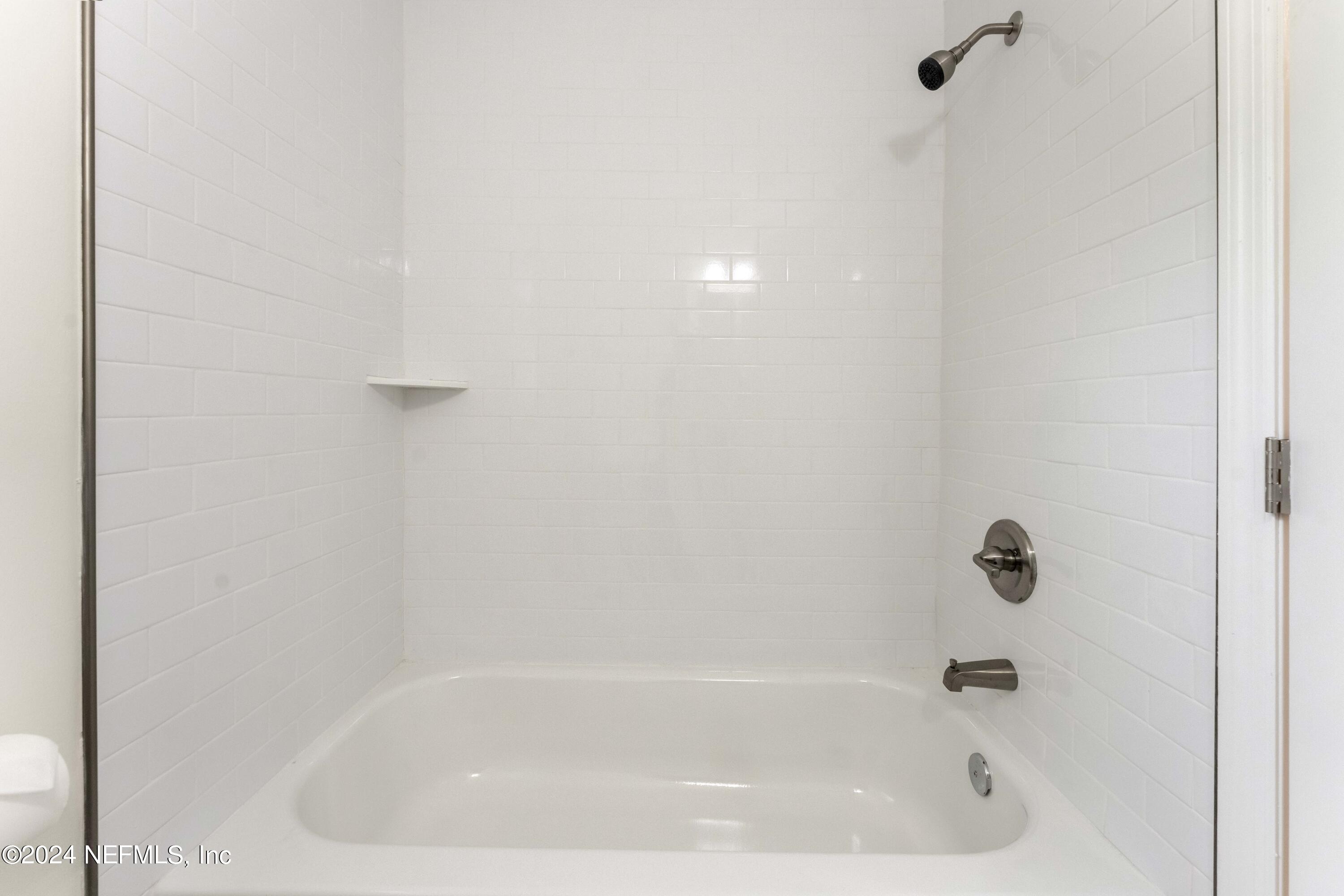 6937 Rollo Road Jacksonville, FL 32205 - Photo 21 of 26 a close up of a bathtub in a bathroom