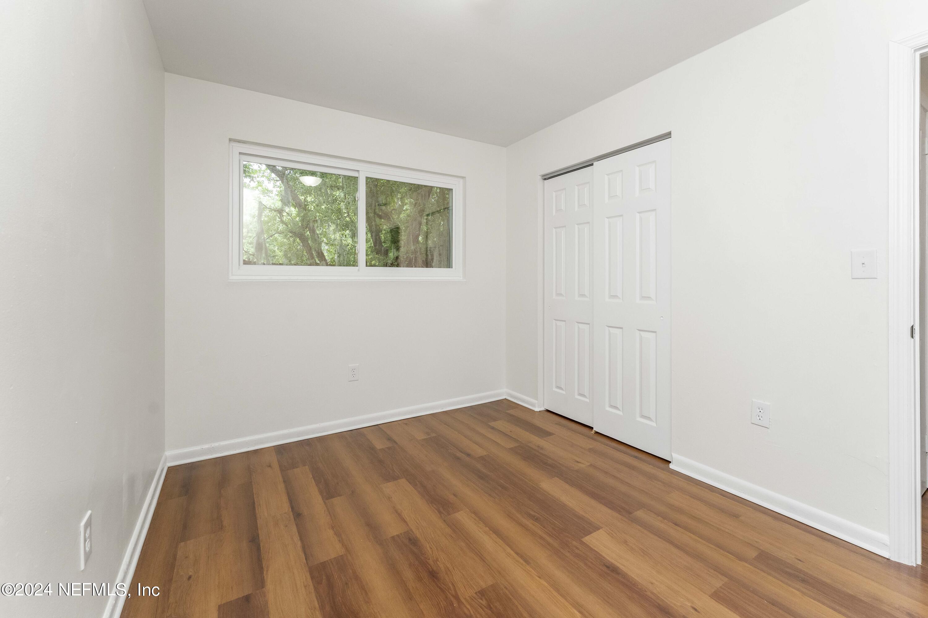 6937 Rollo Road Jacksonville, FL 32205 - Photo 22 of 26 an empty room with a window